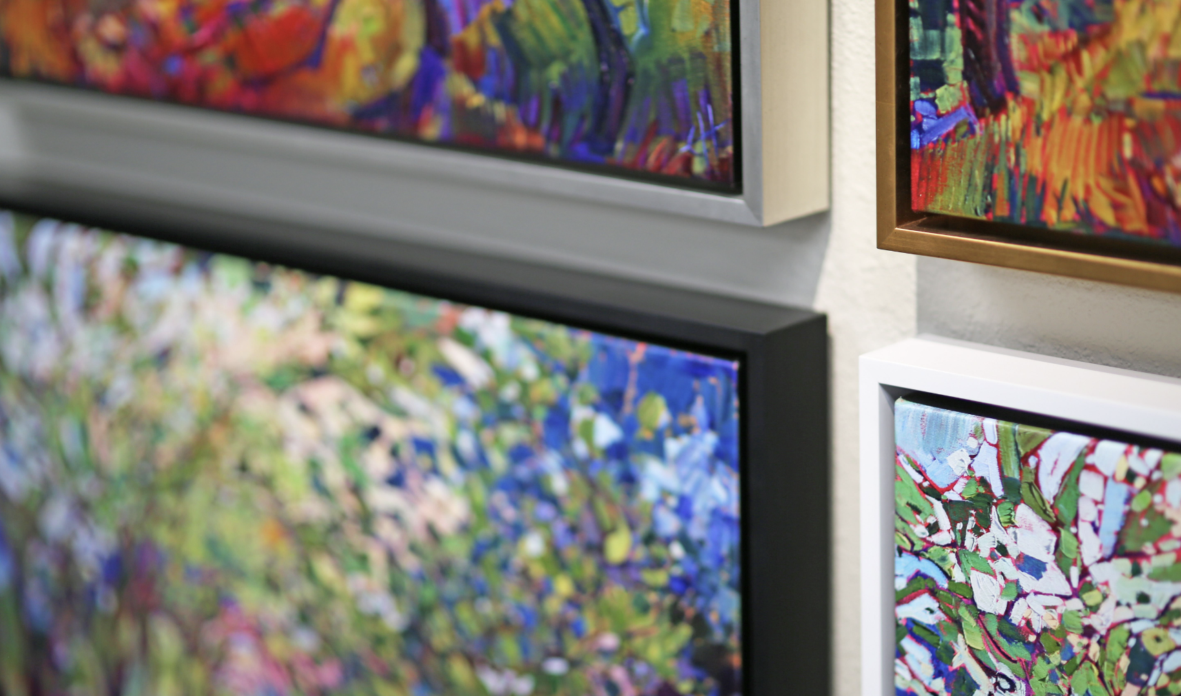 Oil paintings on canvas in float frames hung gallery-style