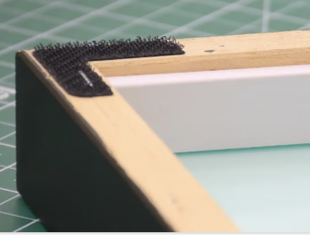 Wooden spacer creating a gap inside a frame