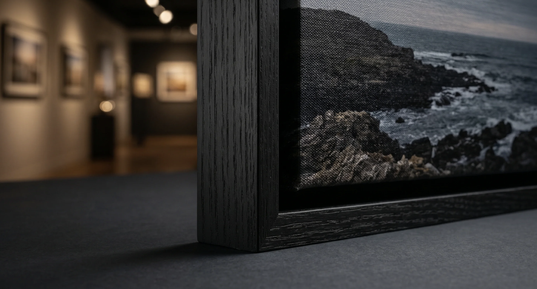 Close-up of a black floating frame corner showing the gap between canvas and frame